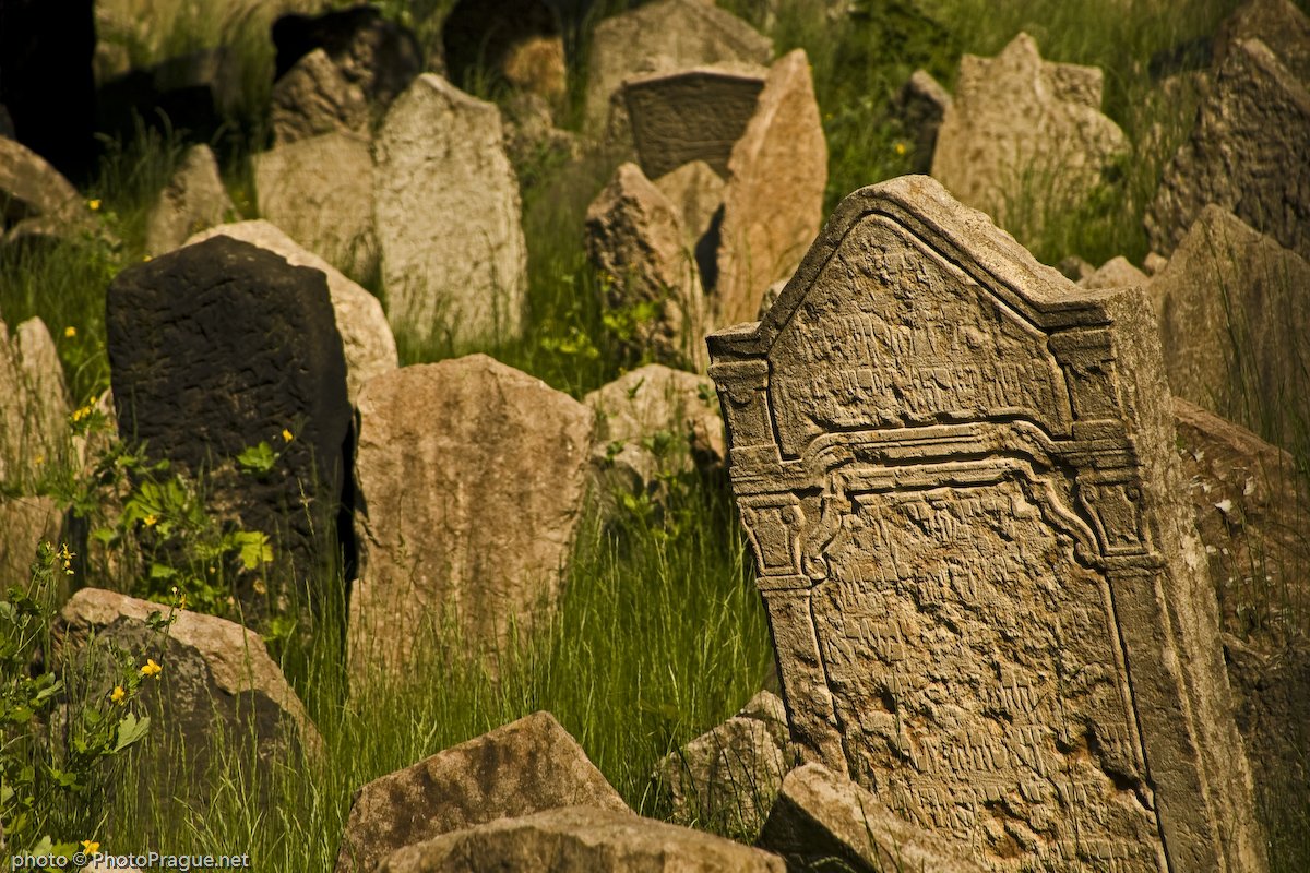 On the grass, many gravestones bear inscriptions in Hebrew.