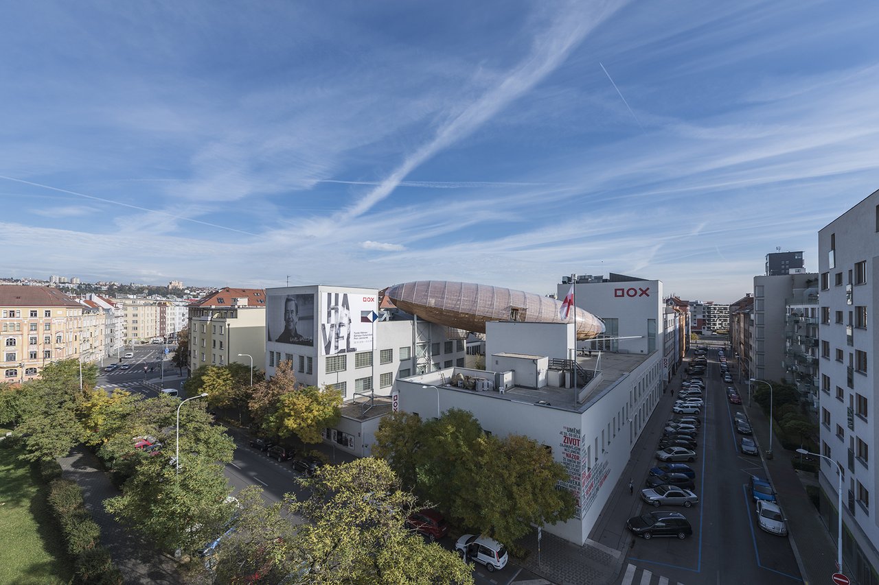 An aerial view of a large, airship-shaped structure perched on the roof of a building